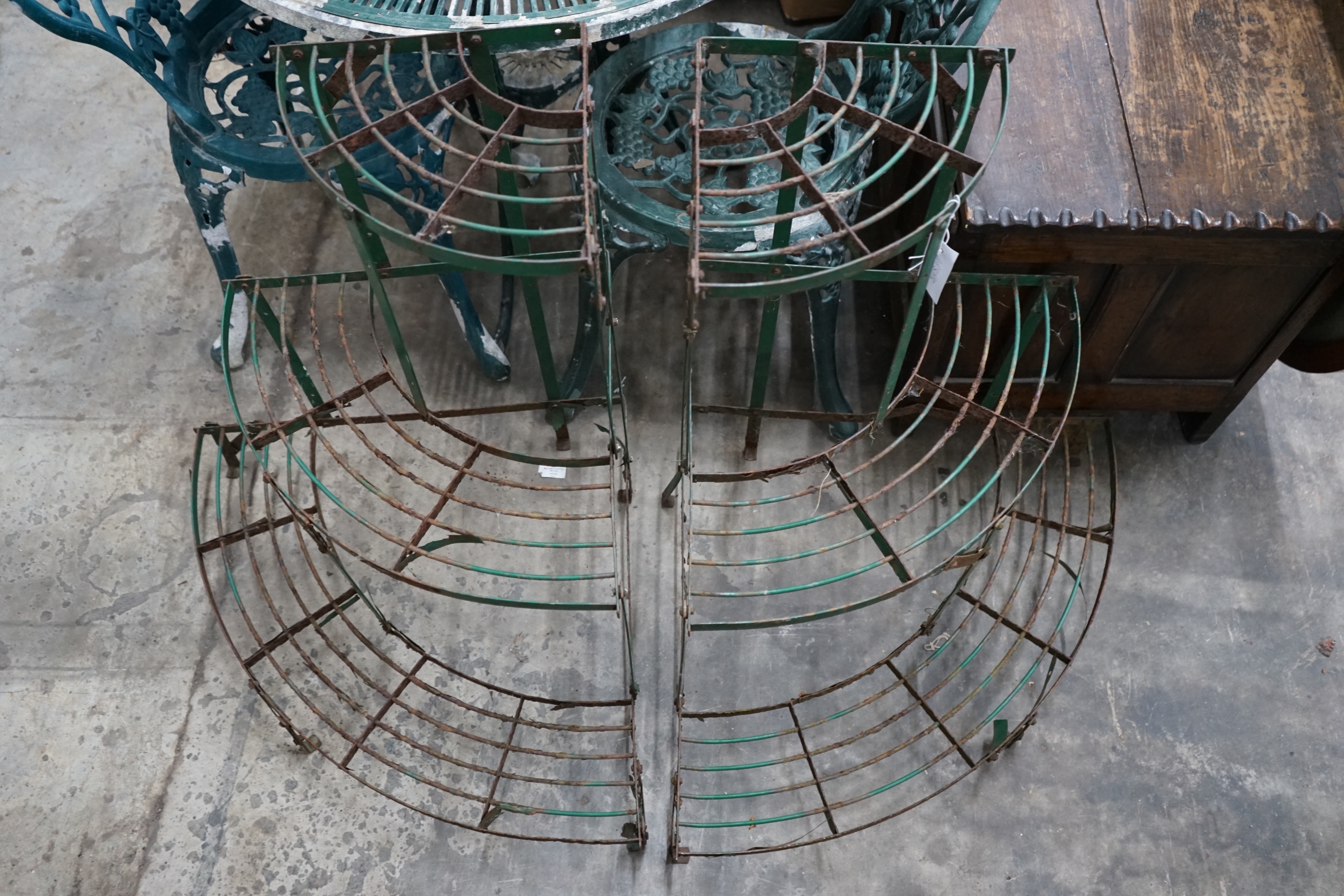 A pair of painted metal three tier corner garden pot stands, height 75cm